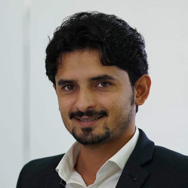 Ali Raza, co-founder of High Range Garage, in a dark blazer and white shirt