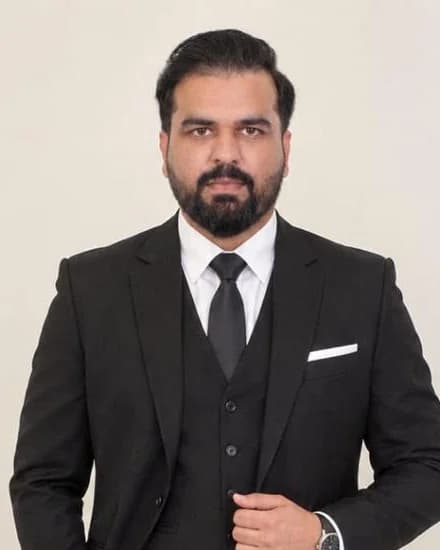 Rehman Arshad, operational manager at High Range Garage, in a black three-piece suit